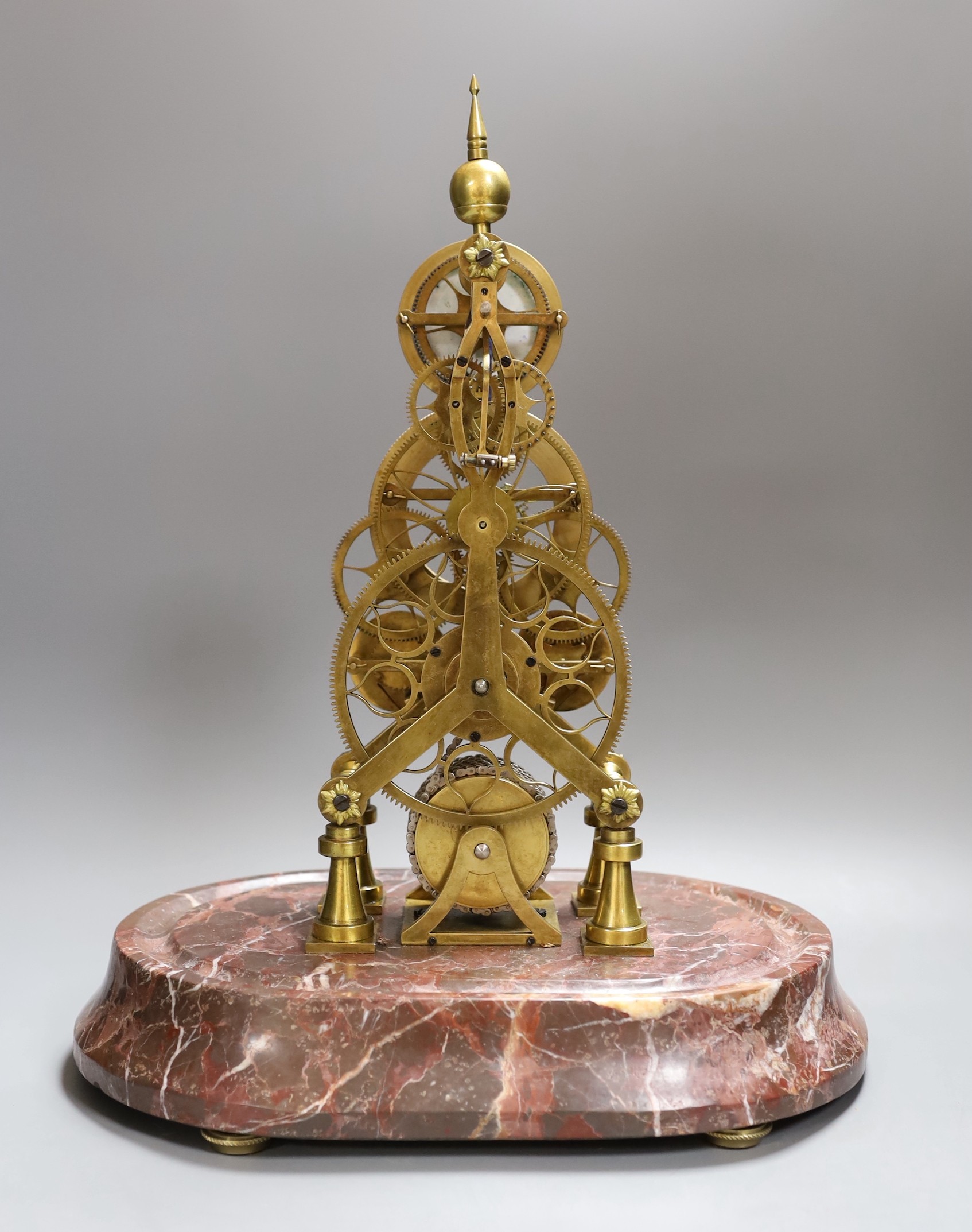 A calendar skeleton clock with moon phase dial, pin wheel escapement, dial signed Franz Denk in Wien, with pendulum, 50cm tall including dome
